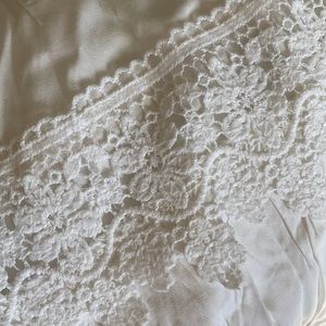 White maxi skirt with lace fringe.